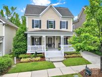 Charming two-story home with a welcoming front porch, manicured lawn, and well-maintained landscaping at 3426 Richards Xing, Fort Mill, SC 29708