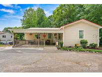 Charming single-Gathering home featuring a cozy front porch and well-maintained landscaping at 3690 Birchwood Ln, Denver, NC 28037