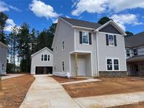 New construction home boasts stone accents, gray siding and black shutters at 4025 Grommet Ct, Matthews, NC 28105