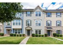 Attractive townhouse showcasing a manicured lawn and inviting entrance with muted colors and natural light at 4038 Zilker Park Dr, Charlotte, NC 28217