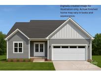 A charming single story home with a two car garage and light gray siding under a dark gray roof at 6203 Flay Rd, Cherryville, NC 28021