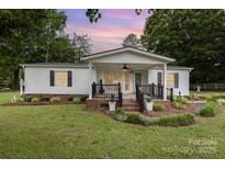 Charming single-story home featuring a welcoming front porch and beautifully landscaped front yard at 733 Osteen Rd, York, SC 29745