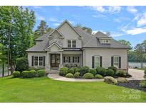 Beautiful two-story home featuring a manicured lawn, stone accents, and a welcoming front entrance at 112 Nautilus Ct, Troutman, NC 28166