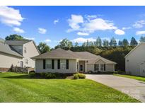 Charming single-story home with manicured lawn and inviting curb appeal at 12013 Regent Ridge Ln, Charlotte, NC 28278