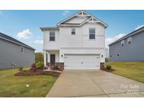 Charming two-story home with a white exterior, a two-car garage, and a well-manicured front yard at 1425 Wildflower St, Newton, NC 28658