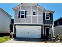 Charming two-story home features a white garage door and a mix of gray and dark siding at 1425 Wildflower St, Newton, NC 28658