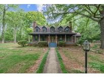 Charming two-story home with a cozy front porch, dormer windows, and a lush green lawn at 1513 Shelby Hwy, Cherryville, NC 28021