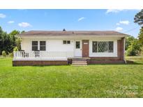 Charming single-story home with a well-manicured lawn, brick accents, and a cozy front porch at 1725 Fallston Rd, Shelby, NC 28150