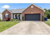 Charming single-story brick home featuring a two-car garage and well-manicured front yard at 1759 Nw Pipers Ridge Cir, Conover, NC 28613