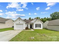 Charming single-story home features a manicured lawn and attached one-car garage at 181 Mott Rd, Mooresville, NC 28115