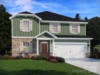 Two-story home featuring green siding, brick accents, a two-car garage, and a well-manicured front lawn at 2155 Sunflower Cir, Newton, NC 28658