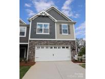 Charming two-story home with stone accents and a two-car garage at 3156 Lilac Grove Dr, Charlotte, NC 28269