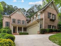 Beautiful brick home with well-manicured landscaping and a spacious driveway at 3825 Mountain Cove Dr, Charlotte, NC 28216