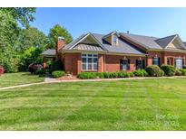 Charming brick home featuring a manicured lawn, mature landscaping, and inviting curb appeal at 532 Wilmslow Rd, Rock Hill, SC 29730