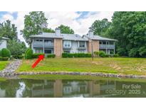Charming two-story condo overlooking a pond with lush landscaping in a serene, wooded neighborhood at 5833 Harris Grove Ln, Charlotte, NC 28212