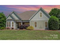 Charming single-story home with well-manicured lawn and lush landscaping at 6603 Havencrest Dr, Denver, NC 28037