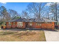 Charming brick home featuring a well-manicured lawn, unique garage door and inviting curb appeal at 851 Gist Rd, Rock Hill, SC 29732