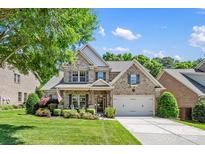 Charming two-story brick home with manicured lawn and welcoming front porch at 9075 Blue Ridge Dr, Indian Land, SC 29707