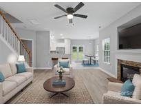 Open-concept living area boasts sleek floors, a fireplace, and seamless transitions to the kitchen and dining spaces at 908 Sundance Dr, Gastonia, NC 28054