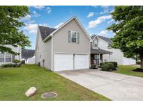 Charming home featuring a two-car garage, manicured lawn, and inviting front porch at 108 Copes Ct, Rock Hill, SC 29732
