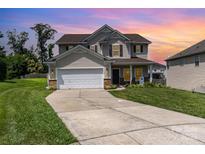 Charming two-story home featuring a two-car garage, inviting front porch and manicured lawn at 11109 Amur Ct, Charlotte, NC 28262
