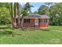 Charming brick home featuring a well-maintained lawn and a welcoming front porch at 1154 Stringfellow Rd, Chester, SC 29706