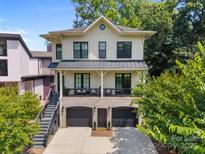 Charming two-story home with a brick-lined garage, covered porch, and inviting curb appeal at 2925 Westfield Rd, Charlotte, NC 28209