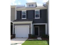 Charming two-story home with gray siding, white trim, garage, and manicured lawn at 746 Lockhaven Nw Dr, Concord, NC 28027