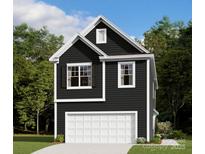 Charming two-story home with a one-car garage, dark siding, and white trim nestled among lush greenery and a blue sky at 753 Lockhaven Nw Dr, Concord, NC 28027