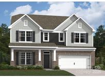 Charming two-story home featuring brick and gray siding, a two-car garage, and well-manicured landscaping at 8585 Acadia Pkwy, Sherrills Ford, NC 28673