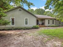 Charming single story home featuring vinyl siding and mature trees at 17501 Youngblood Rd, Charlotte, NC 28278