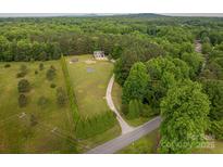 A beautiful, wooded, aerial view of the home and surrounding landscape at 2609 Cove Creek Dr, Gastonia, NC 28056