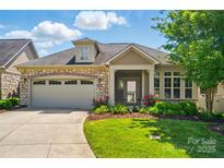 Charming single-Gathering home boasts a stone and siding exterior, well-manicured lawn, and a two-car garage at 5028 Polo Gate Blvd, Charlotte, NC 28216
