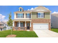 Charming two-story home with a well-manicured lawn, inviting front porch, and a two-car garage at 545 Stroupe Rd, Gastonia, NC 28056