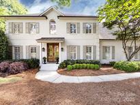 Stunning two-story painted brick home with a beautifully landscaped front yard and a striking, inviting double-door entryway at 5822 Alexa Rd, Charlotte, NC 28277