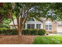 Charming home exterior featuring stone accents, manicured landscaping, and large windows at 9013 Trellis Pointe Blvd, Charlotte, NC 28227