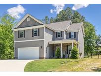 Charming two-story home featuring a two-car garage, covered porch, and well-maintained lawn at 9115 Providence S Rd, Waxhaw, NC 28173