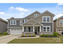 Charming two-story home with a welcoming front porch and well-manicured lawn in a lovely neighborhood at 1601 Calder Dr, Indian Trail, NC 28079