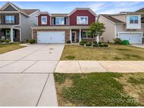 Two-story home with brick and siding exterior, well-manicured lawn, two car garage, and inviting entryway at 1723 Loggerhead Dr, Lancaster, SC 29720