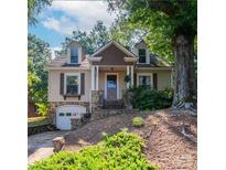 Charming home with stone accents, dormer windows, and a well-maintained yard and stairs to the entrance at 208 N 5Th St, Albemarle, NC 28001
