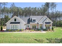 Beautifully landscaped, single-Gathering home with a light grey exterior and black window accents at 2396 Lee Lawing Rd, Lincolnton, NC 28092
