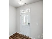 Bright foyer features a white front door with glass panes and wood flooring at 2405 Hedgecliff Rd, Kannapolis, NC 28025