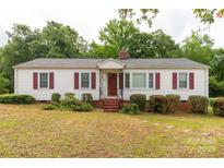 Charming single-story home with red shutters and a well-manicured front yard at 439 Kershaw Country Club Rd, Kershaw, SC 29067