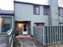 Two-story townhome exterior with light green painted siding and entry walkway at 6134 Bent Tree Ct, Charlotte, NC 28212