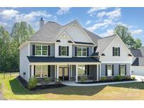 Stunning two-story home featuring a covered porch and a beautifully landscaped front yard at 6814 Forney Hill Rd # 2, Denver, NC 28037