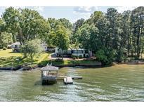 Stunning lakefront property featuring a private pier and lush greenery, offering a serene retreat at 9115 Clement Cir, Terrell, NC 28682