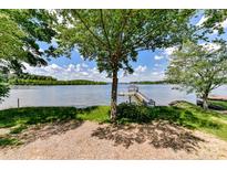 Lush backyard with mature trees leading to a private dock and lake access at 9115 Clement Cir, Terrell, NC 28682