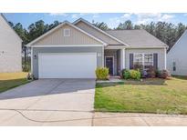 Charming single-story home with a well-manicured lawn and attached two-car garage, perfect for suburban living at 1109 Culver Spring Way, Charlotte, NC 28215