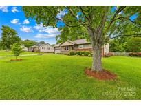 Charming single-story home with well-maintained lawn, tree, and cozy front porch at 117 Ethel Ln, Statesville, NC 28625