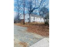 Cozy white home featuring a fenced yard and mature trees at 1336 Norris Ave, Charlotte, NC 28206